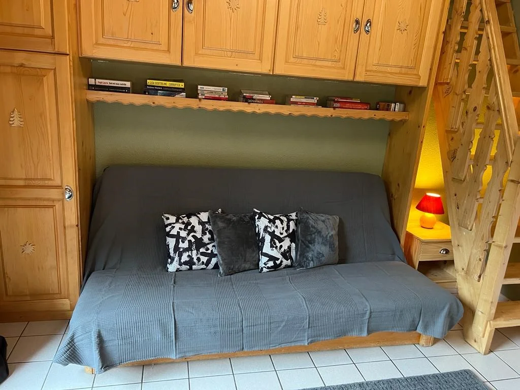 Living room sofa beneath the wooden cupboards